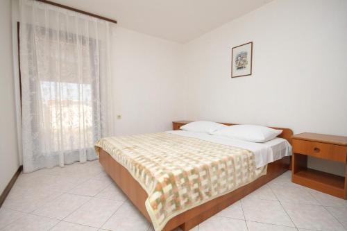 a bedroom with a bed and a window at Apartment Banjole 7487a in Banjole