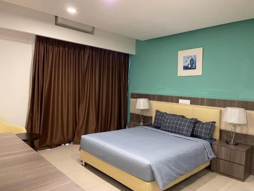 a bedroom with a bed and a blue wall at TopSuites at Ion-Delemen Genting Highlands in Genting Highlands