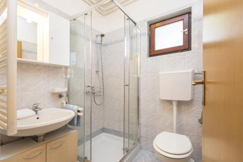 a bathroom with a shower and a toilet and a sink at Apartment Vinez 7471a in Labin
