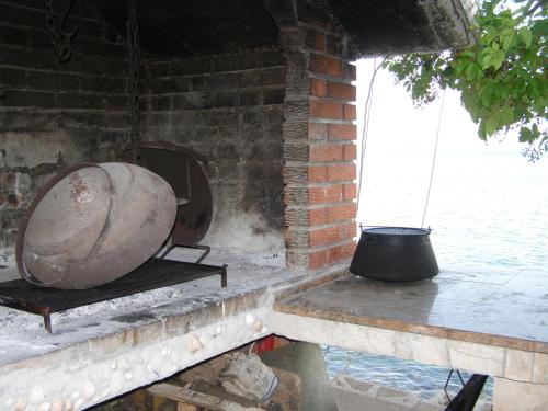 a large object sitting on a table next to a brick wall at Apartments by the sea Seget Vranjica, Trogir - 7508 in Seget Vranjica