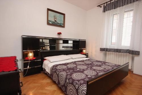 a bedroom with a large bed in a room at Apartments with a parking space Funtana, Porec - 7414 in Funtana