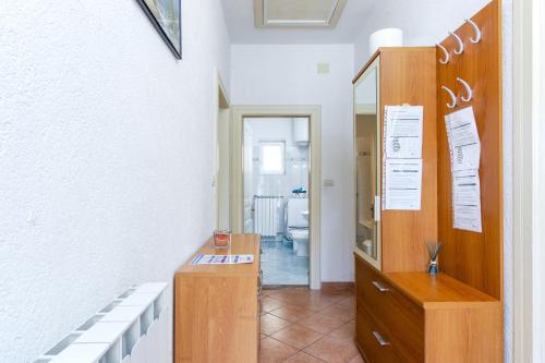 a room with a wooden dresser and a mirror at Seaside holiday house Plomin Luka, Labin - 7466 in Plomin