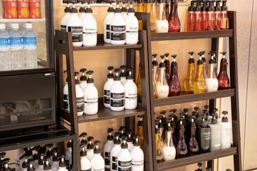 a bunch of bottles of alcohol on shelves in a store at Court Hotel Mito in Mito