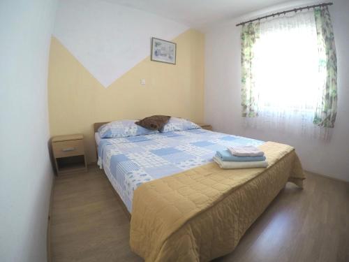 a bedroom with a bed with a dog laying on it at Apartments and rooms by the sea Bibinje, Zadar - 6199 in Bibinje