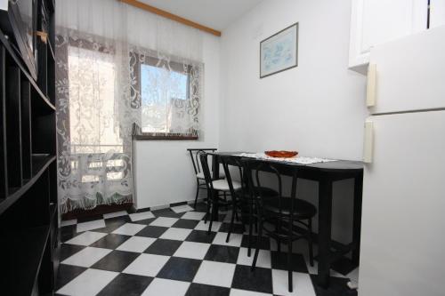 a kitchen with a black and white checkered floor at Apartments and rooms by the sea Bibinje, Zadar - 6199 in Bibinje