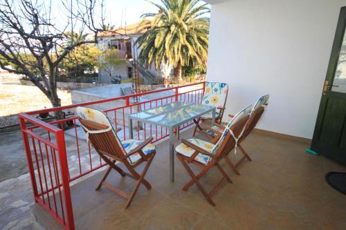 a table and chairs sitting on a balcony at Apartments by the sea Slatine, Ciovo - 7544 in Slatine