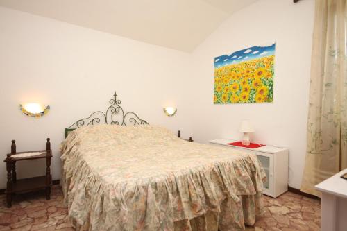 a bedroom with a bed and a painting on the wall at Seaside holiday house Razanj, Rogoznica - 7514 in Rogoznica