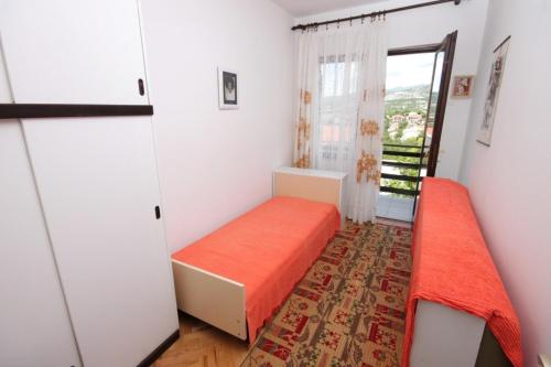 a small room with a bed and a window at Apartments with parking spaces Klenovica, Novi Vinodolski - 7605 in Klenovica
