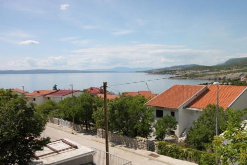 a view of the water from a town with houses at Apartments with parking spaces Klenovica, Novi Vinodolski - 7605 in Klenovica