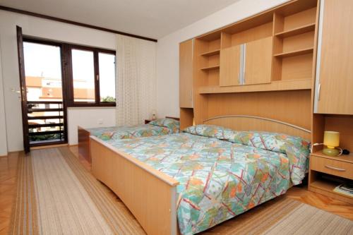 a bedroom with a bed in a room at Apartments with a parking space Peroj, Fazana - 7516 in Vodnjan