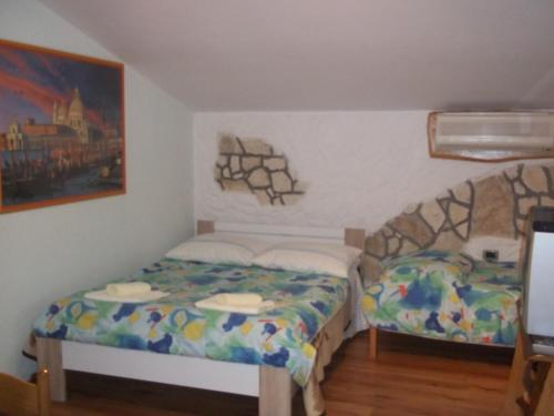 a bedroom with two beds and a painting on the wall at Apartments with a parking space Sveti Martin, Central Istria - Sredisnja Istra - 7634 in Labin