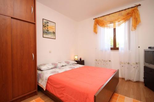 a bedroom with a bed and a window at Apartments with a parking space Presika, Labin - 7617 in Labin