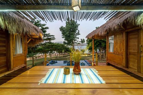 a wooden table with a vase on top of it at Catappa Village Lombok in Sekotong