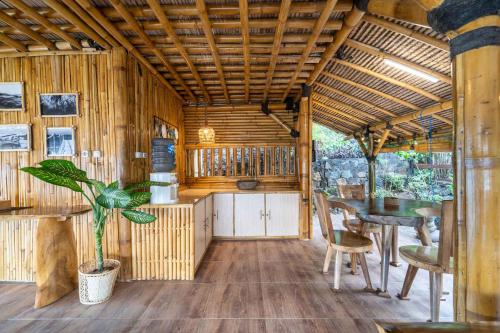 a kitchen with a table and a dining room at Catappa Village Lombok in Sekotong