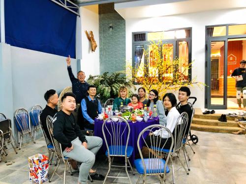 a group of people sitting at a table at 150 Homestay in Dong Hoi