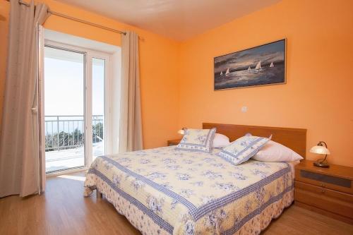 a bedroom with a bed and a large window at Holiday house with a swimming pool Gornja Podgora, Makarska - 5985 in Podgora