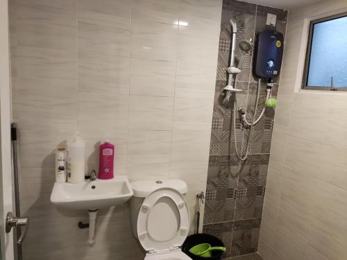 a small bathroom with a toilet and a sink at Homestay 116 in Ipoh