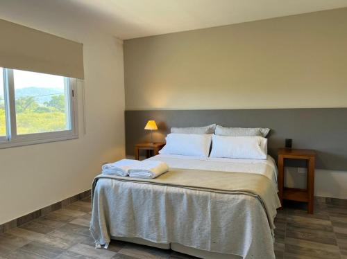 a bedroom with a large bed with two towels on it at Tierras del Norte in Salta