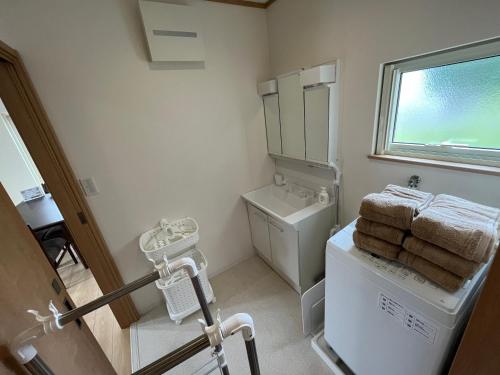a small bathroom with a washer and dryer at 白浜貸別荘2-76 in Kanayama