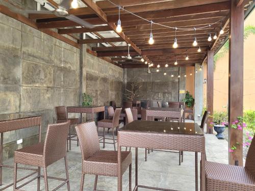 a restaurant with tables and chairs on a patio at North Tourist Inn in Bacolod