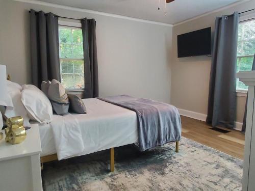a bedroom with a bed and a television in it at Cheerful 2 BR Near Colleges, Downtown, Attractions in Montgomery