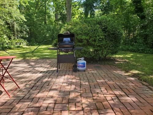 a grill on a brick patio with a bbq at Cheerful 2 BR Near Colleges, Downtown, Attractions in Montgomery