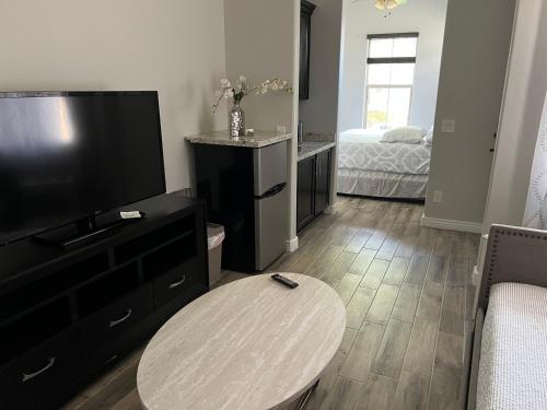 a living room with a table and a television at Queen creek az casita in Queen Creek
