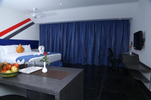 a hotel room with a bed and a table with fruit on it at Days Inn & Suites by Wyndham Bengaluru Whitefield in Bengaluru