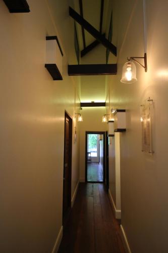 an empty hallway with a hallway leading to a door at Baan Luang Rajamaitri Historic Inn in Chanthaburi