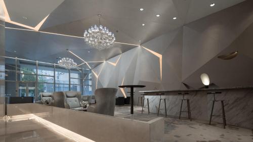 a living room with a chandelier and a table at Holiday Inn Beijing Focus Square by IHG in Beijing