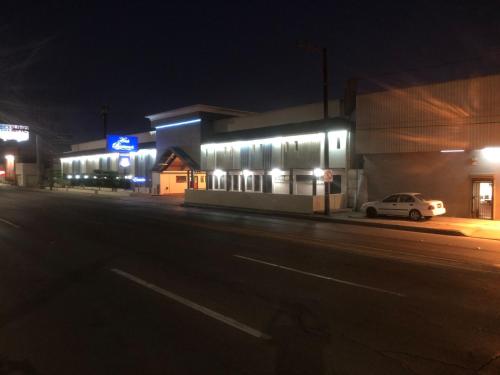 a car parked in front of a building at night at Hotel Boulevard Mexicali in Mexicali