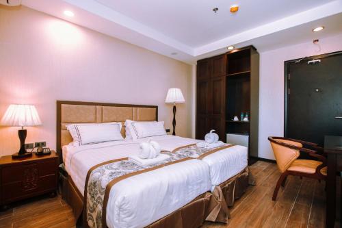 Postel nebo postele na pokoji v ubytování Palawan Uno Hotel