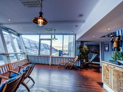 a lobby with chairs and a view of mountains at Radisson Blu Hotel Tromsø in Tromsø