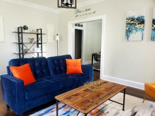 a blue couch in a living room with orange pillows at Spacious Centrally Located 3 Bed 2 Bath - Sleeps 8 in Montgomery