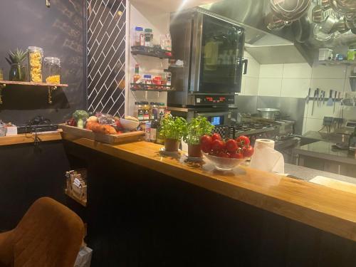 a kitchen with a counter with fruits and vegetables on it at Boutique Hotel Ravioli Brothers in The Hague