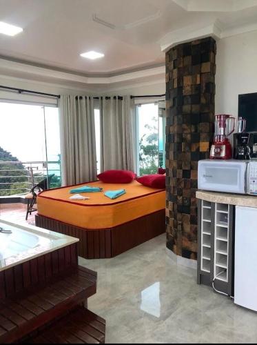 a bedroom with a large bed in a room at Pousada Mirante do César in Bombinhas