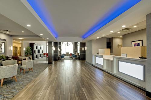 an empty lobby with a blue ceiling at Holiday Inn Express Nashville-Opryland by IHG in Nashville