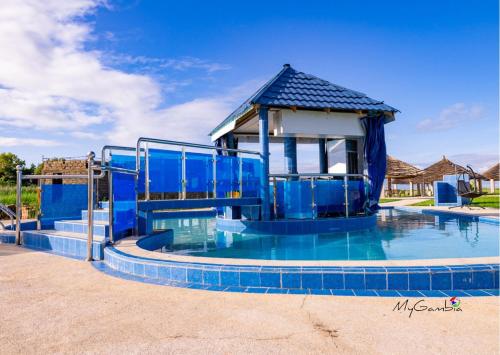 a blue water slide in a swimming pool at Bojang River Lodge in Bakau