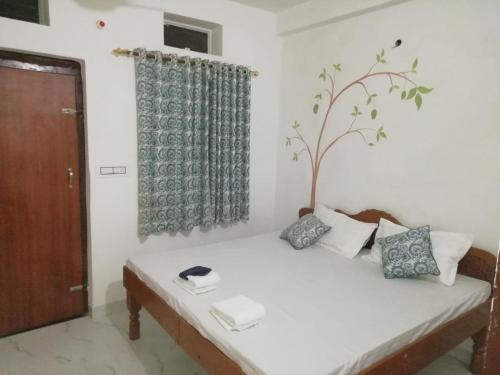 a room with a bed with a tree on it at Cocoon Auberge in Jaipur