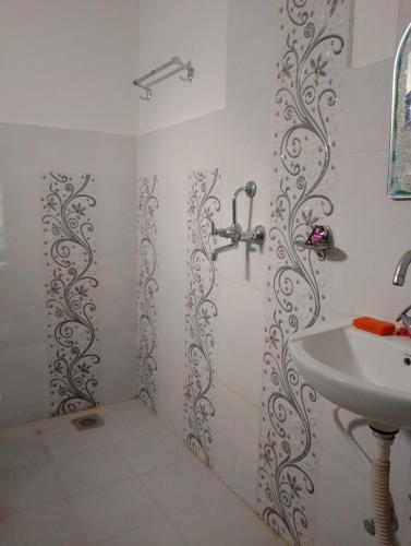 a bathroom with a shower and a sink at Hotel small town guest house in Bandīpur