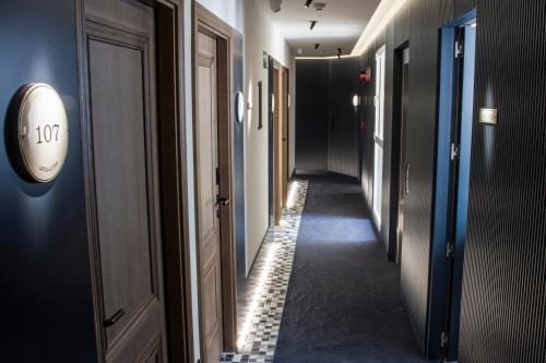 a corridor of a hallway with a clock on a wall at Letoh Letoh Gran Vía in Madrid