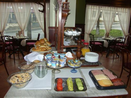 a table with a bunch of food on it at Adler Hotel in Budaörs