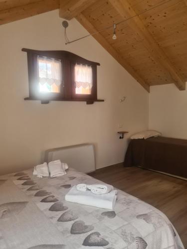 a bedroom with a bed with two towels on it at La casa del gnocco in Masone