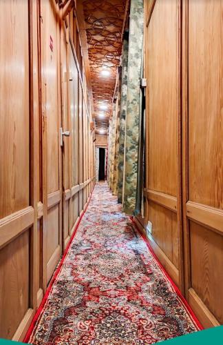 a long hallway with a rug on the floor at Lake Victoria Houseboats in Srinagar