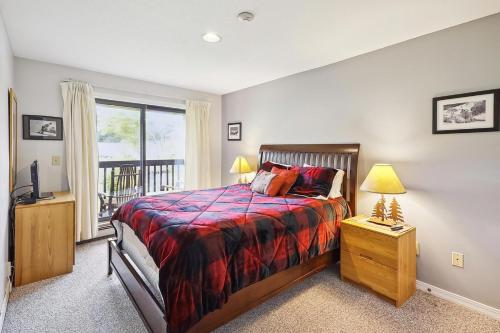a bedroom with a bed and a window and a television at Pico F305 in Killington