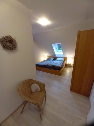 a bedroom with a bed and a chair in a room at Alte Mühle in Holzminden