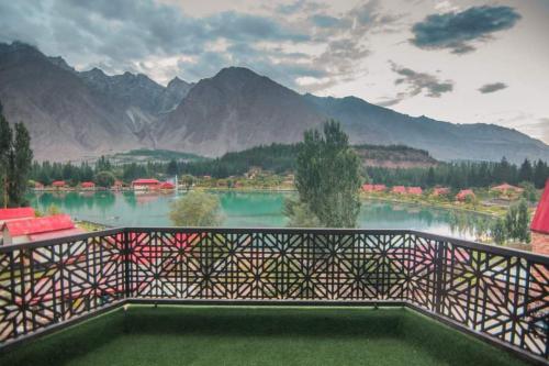 a balcony with a view of a lake and mountains at Tibet Hotel in Skardu
