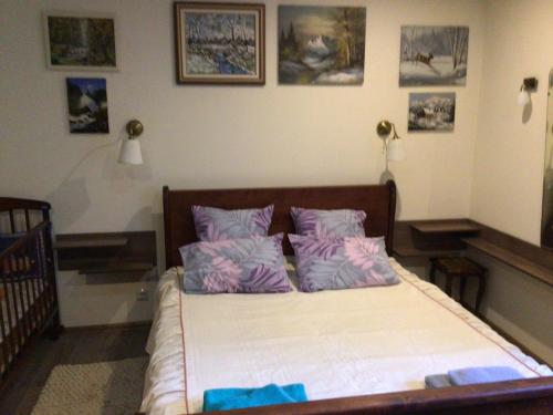 a bed with purple pillows in a bedroom at Квартира in Yaremche