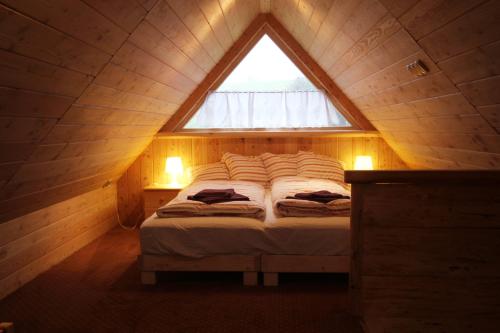 a bed in a small room with a window at Tutok in Zakopane
