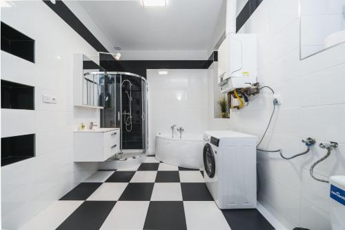 a bathroom with a black and white checkered floor at Barbakan Residence Old Town in Krakow